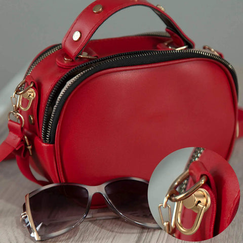 Close-up of red purse with 12 Pieces D Ring Stud Screws With Ball Head Buttons For Purses And Leather DIY Projects in gold.
