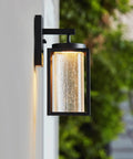 Capulet Amber Glass Center Column Outdoor Indoor Wall Sconce With LED Black Finish, Dimmable 12W 850 Lumens on wall