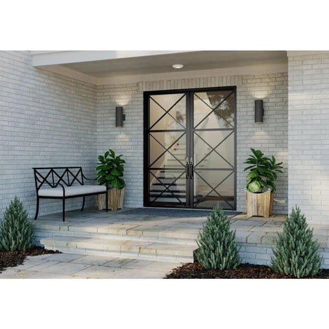 Exterior view with Dope Modern 5 Inch Outdoor Up And Down Wall Lantern In Black Finish flanking entryway doors on brick wall.