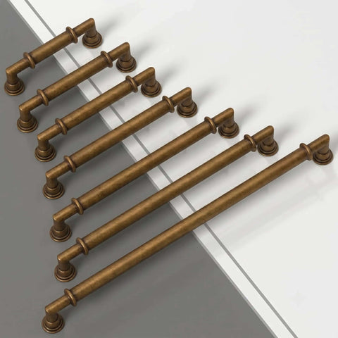 Top view of 10 Pack Antique Brass Cabinet Pulls, 3 Inch Zinc Alloy Drawer Handles For Kitchen Cupboards displayed on a surface.