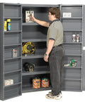 Man organizing tools inside Workhorse Steel Storage Cabinet With Adjustable Interior Shelves And Heavy Duty Deep Pocket Doors.