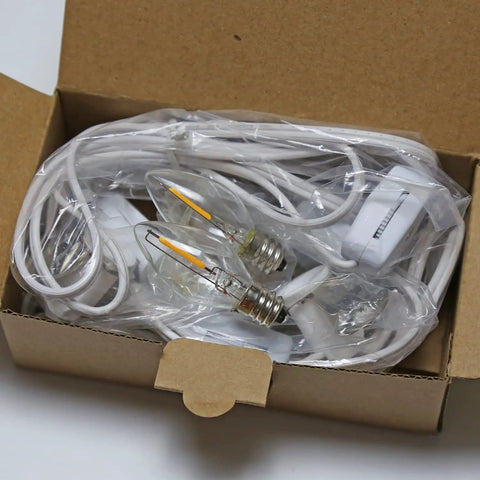 Two Pack LED Light Cords With 6 Feet White Wire And On Off Switch, C7 Candelabra Bulbs And Clips in open box