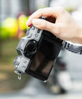 XT30III Pro Thumb Grip With Shutter Button For XT30II XT20 XT10 Mirrorless Cameras shown on camera in hand outdoors