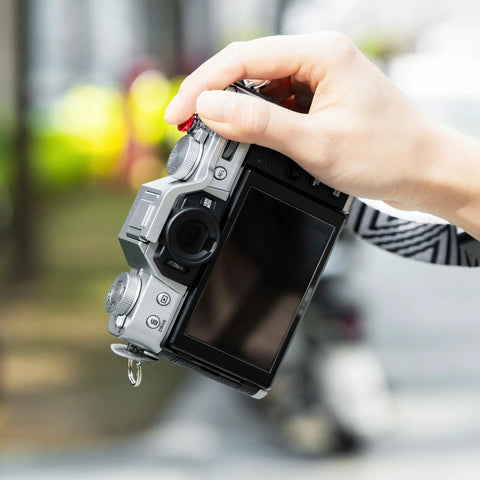 XT30III Pro Thumb Grip With Shutter Button For XT30II XT20 XT10 Mirrorless Cameras shown on camera in hand outdoors