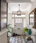 Industrial Pendant Light With Classic Black Metal Cage For Farmhouse And Modern Homes in white hallway with patterned floor