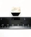 Close-up of adhesive-backed Three Quarters Inch Wide Pyramid Silicone Rubber Bumper Feet with ruler for size reference.