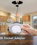 Hand holding Six Pack E26 Light Socket Adapter Pigtail For LED Ceiling Downlights Plug And Play Screw In Male Socket Converter