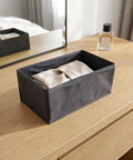Super Sturdy Foldable Drawer Clothing Organizer Set Eight Piece Gray Fabric Wardrobe Dividers with folded item on a dresser.