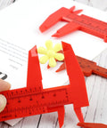 Depth Vernier Caliper Micrometer Gauge Measuring Tool measuring a yellow flower, red plastic design, ideal for creative projects.