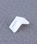 28 Pack White Plastic Corner Brackets For Furniture Reinforcement Anti Slip Desk And Chair Corner Braces on grey surface