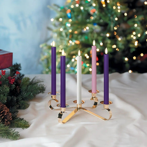 Festive scene with five colorful taper candles on a gold holder, glowing against a decorated Christmas tree backdrop.