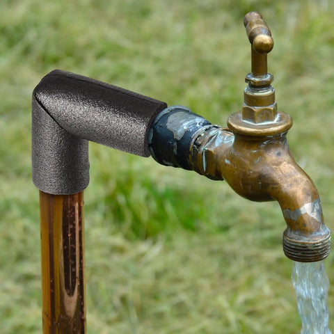 Black elbow insulation foam tube installed on outdoor brass faucet, part of 8 Pack Black Elbow Pipe Insulation Foam Tubes For Outdoor Use Easy Install Weatherproof Pipe Covers And Insulation Tubing For Water Lines Sprinklers And Irrigation Systems 1 Inch Fit For Outdoor Winter Protection.