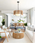 A Straight Up Game Changer 4Light Rattan Chandelier With Linen Drum Shades illuminates a modern dining area, featuring natural wicker.
