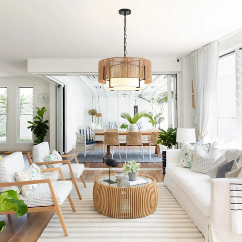 A Straight Up Game Changer 4Light Rattan Chandelier With Linen Drum Shades illuminates a modern dining area, featuring natural wicker.