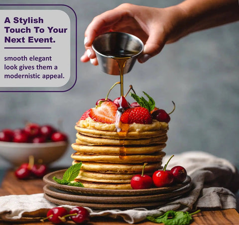 Person pouring syrup from Stainless Steel Sauce Cups Set 12-Pack Small Dipping Ramekins for Condiments onto pancakes.