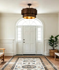 XSDeTu Farmhouse Metal Pendant Light, 2‑Tier Chandeliers for Dining Room illuminating a foyer with wooden bench and rug.