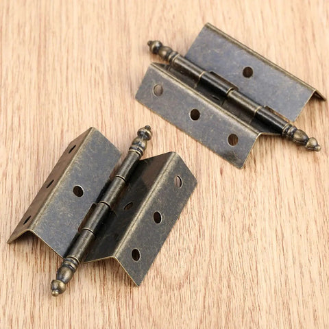 Antique Bronze Hinges Set For Wood Boxes And Cabinets, Vintage Style Door Hardware With 16 Screws, 8 Hole Crown Design on wood surface