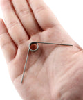 Hordion 2in stainless steel torsion spring, 1mm wire, 11mm outside diameter, 90-degree bend, held in hand