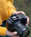 Person holding a camera with a 44mm Quick Release Tripod Plate Mount Adapter For Cameras And Video Gear Universal 1 3 4 Inch Square Base.