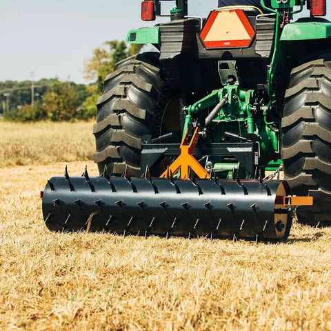 Six Foot Drum Spike Aerator For 3 Point Hitch On Cat 1 And Cat 2 Tractors in use on dry field for soil perforation