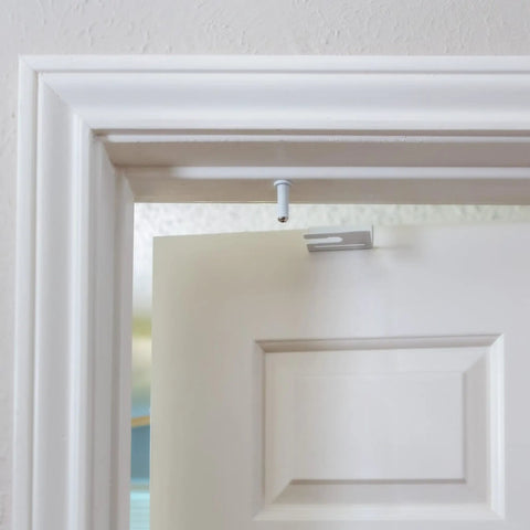 Close-up of top mount latch of Straight Up Secure Metal Child Safety Door Lock For Ultimate Home Security, white color.
