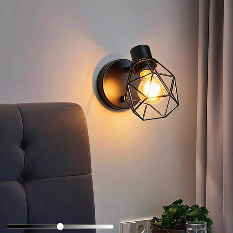 Black Industrial Wall Sconce With Dimmer And On Off Switch, adjustable cage head lighting beside a gray armchair