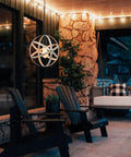 Outdoor view of industrial spherical pendant light with changeable cage design, 15 ft cord, ash wood finish in cozy setting