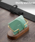 Walnut Wood Business Card Holder For Desk And Office with brass accents holding cards, on a wooden tabletop setup