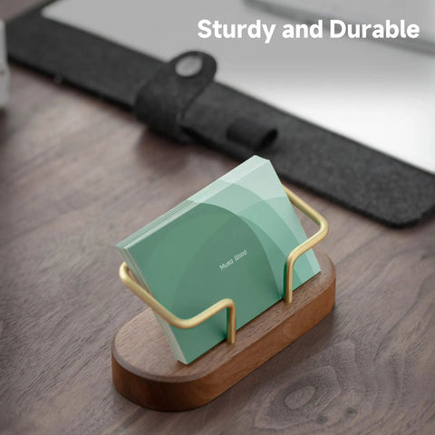 Walnut Wood Business Card Holder For Desk And Office with brass accents holding cards, on a wooden tabletop setup