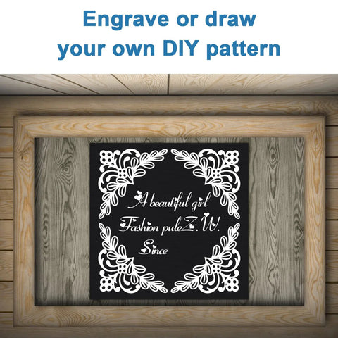 Front view of a black anodized aluminum engraving blank with a white floral border, framed in a wooden display