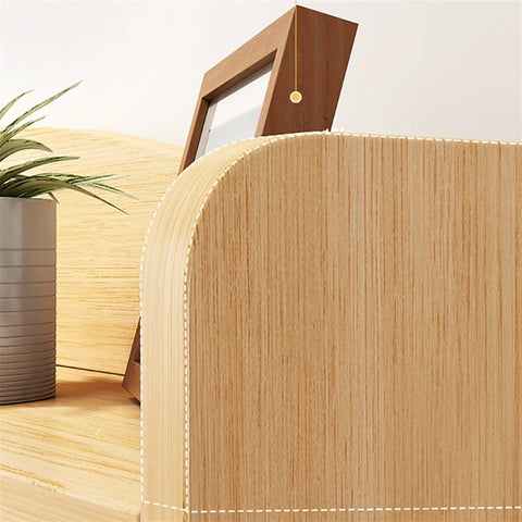 Close-up of Rock Solid Electric Standing Desk L Shaped Computer Workstation with smooth rounded edges and wood grain finish.