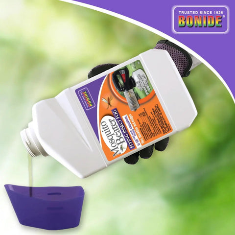 Person holding Mosquito Beater Flying Insect Fog Concentrate for Lawn and Garden 32 Oz, pouring liquid into a fogger.