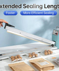 Rock Solid Impulse Heat Sealer With 20 Inch Wide Seal Bar sealing plastic bags with walnuts, showcasing snap lock handle and extended length.