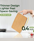 Hand holding dishwasher safe carbonized bamboo cutting board with juice groove, size 10.4" x 8", showing thin 0.4" design.