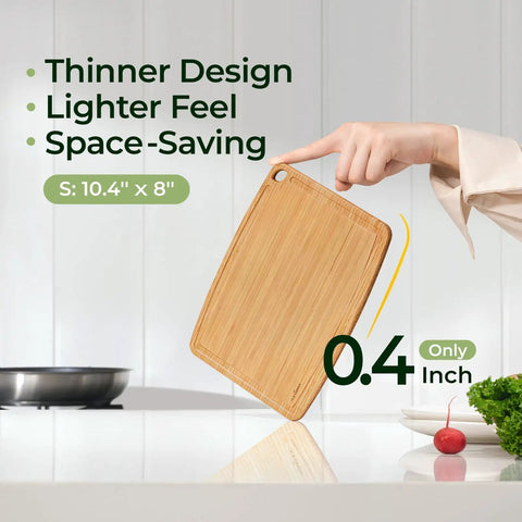 Hand holding dishwasher safe carbonized bamboo cutting board with juice groove, size 10.4" x 8", showing thin 0.4" design.