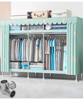 Top Tier Portable Closet Wardrobe Cover For Bedroom Kick Clutter To Curb Featuring triple hanging rods and multiple fabric shelves in green.
