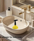 Compact Mini Sink Drain Plunger With Short Handle And Heavy Duty Rubber Cup features ergonomic grip in bathroom sink.
