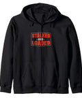 Black zip hoodie with 'Stalked And Loaded' graphic. Funny Combine Harvester Operator Zip Hoodie For Harvest Crew Who Love Rolling Big Machines Cozy Farm Workwear With Real Crop Field Vibe Perfect Gift For Field Hands And Agribusiness Fans