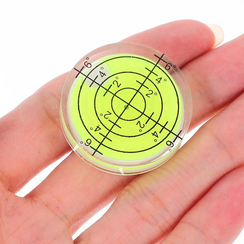 Four Pack Mini Bubble Level Ruler Set High Precision Compact Plastic Design in hand, detailed view of circular level indicator