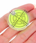 Close-up of a circular bubble level from the 4 Piece Mini Bubble Level Tool Set for Construction and Mechanical Work, compact design.