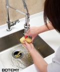 Person using faucet over a sink with extended stainless steel garbage disposal basket strainer with flange for standard 3.5 inch drain