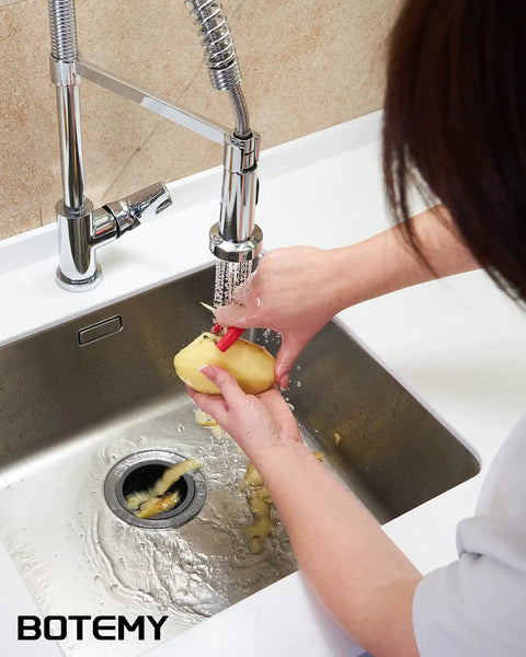 Person using faucet over a sink with extended stainless steel garbage disposal basket strainer with flange for standard 3.5 inch drain