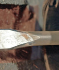 1 Inch By 18 Inch Flat Chisel For SDS Max Hammer Steel Beefy Heavy Duty Concrete Removal on a brick surface close-up
