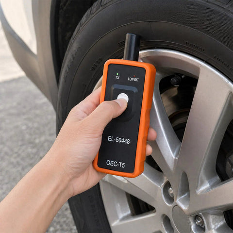 Pro TPMS Reset Tool For Fast Tire Pressure Sensor Activation And One Button Relearn handheld device in use on a car tire.