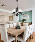 Affordable Luxury Five Light Farmhouse Chandelier In Classic Black Finish above dining table with pendant lighting and glass shades.