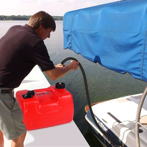 Person using 3 Gallon Marine Fuel Tank With Line And Pump, I Shaped Handle, Outboard Boat Gas Tank For Marine Engines on a dock