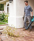 Man using 18V LXT Brushless Cordless Blower With Cruise Control, Variable Speed Trigger, And Speed Lock For Continuous Operation, Tool Only, on patio