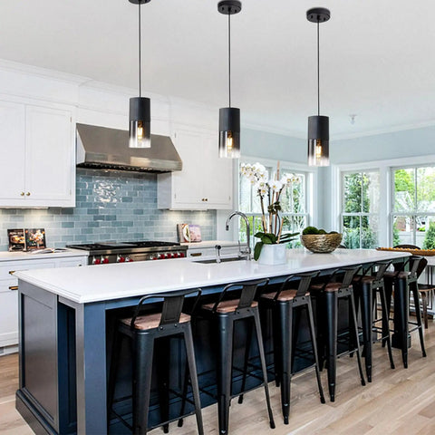 Two Pack Adjustable Black Gradient Glass Pendant Lights With Matte Black Finish above kitchen island