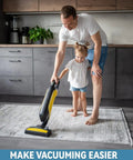 Father and daughter vacuuming a rug on hardwood floor using Large Double Sided Rug Tape That Keeps Area Rugs In Place On Hardwood Floors And Tile Reusable Non Slip Pad No Damage Grippers For High Traffic Rooms Quick Install With Grippy Hold And Easy Removal.