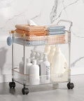 Sleek Clear Acrylic 2 Tier Rolling Utility Cart With Sturdy Handle And Smooth Lockable Wheels Compact Storage Trolley For Kitchen Bathroom Tight Spaces Easy Clutter Control Game Changer with towels and bottles.